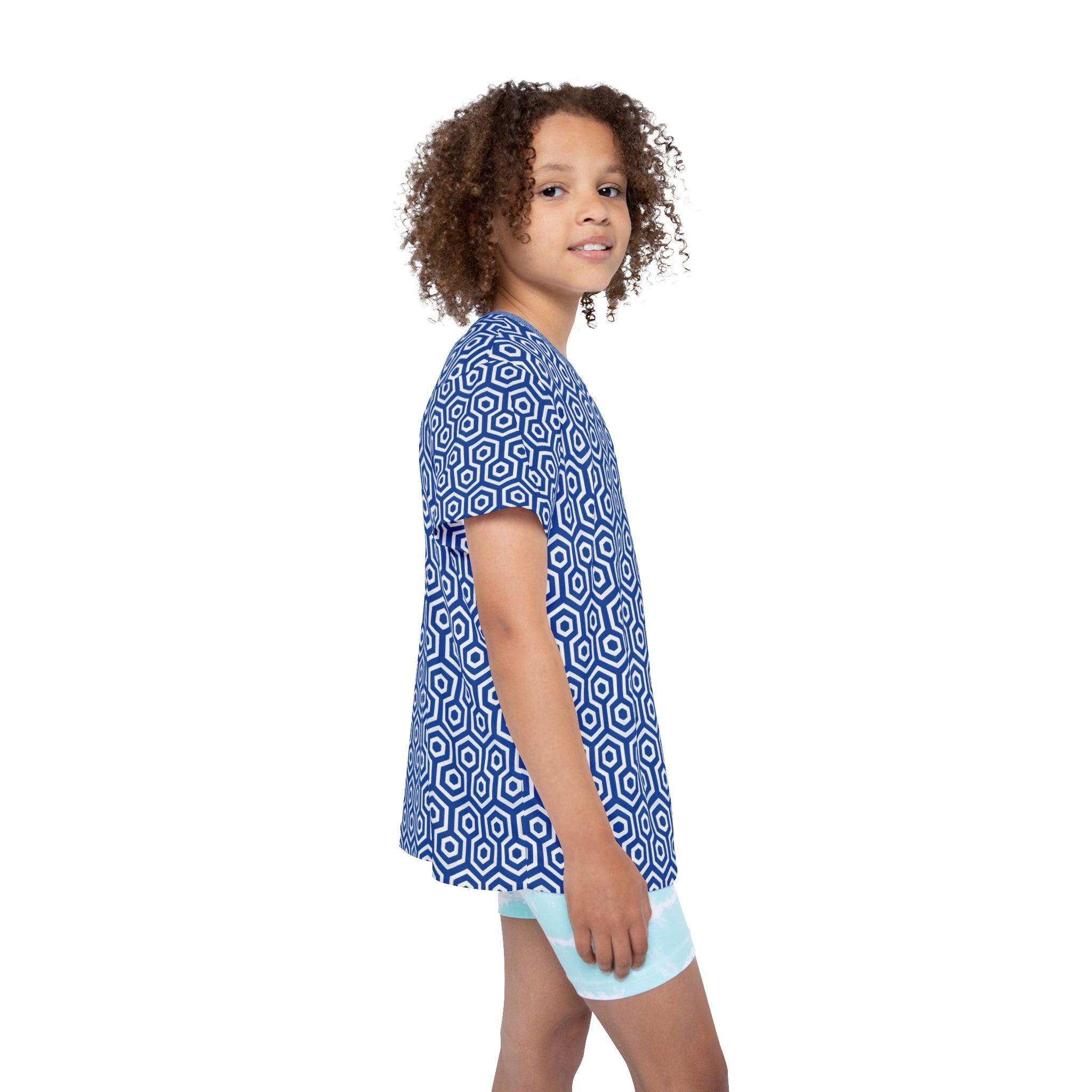 Child wearing a blue geometric patterned shirt and light blue shorts on a white background