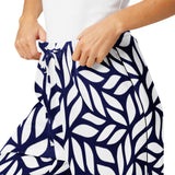 Person wearing a navy and white patterned skirt on a white background