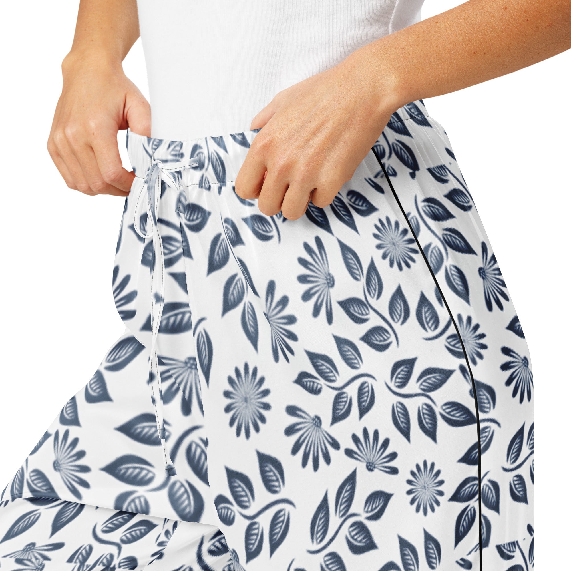 Person wearing a white skirt with blue floral pattern