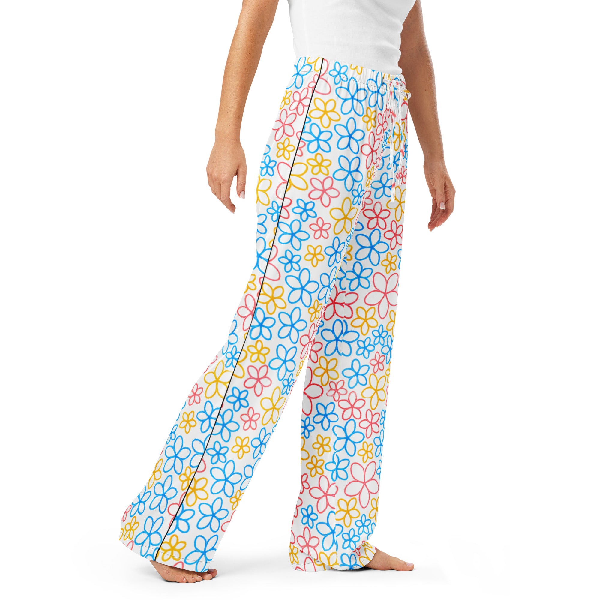 Colorful floral-patterned pants worn by a person on a white background
