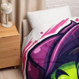 Bed with colorful bedding next to a wooden nightstand and lamp.