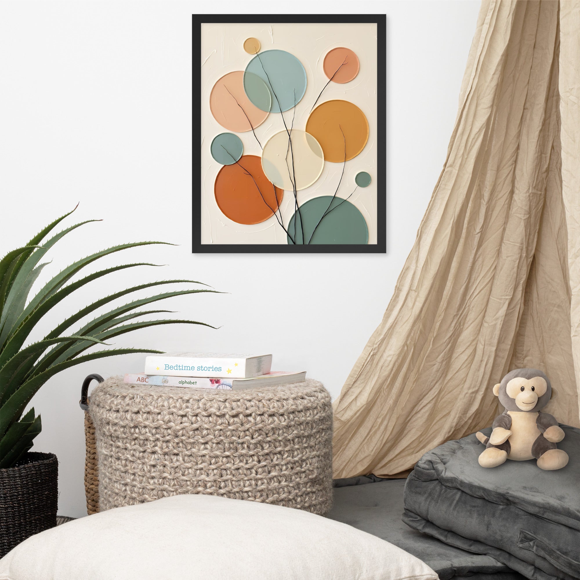 Decorative abstract art piece on a wall above a woven basket with books, a plush monkey toy, and pillows.