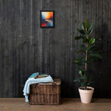 Wicker basket with folded clothes against a dark wooden wall with a colorful abstract painting.