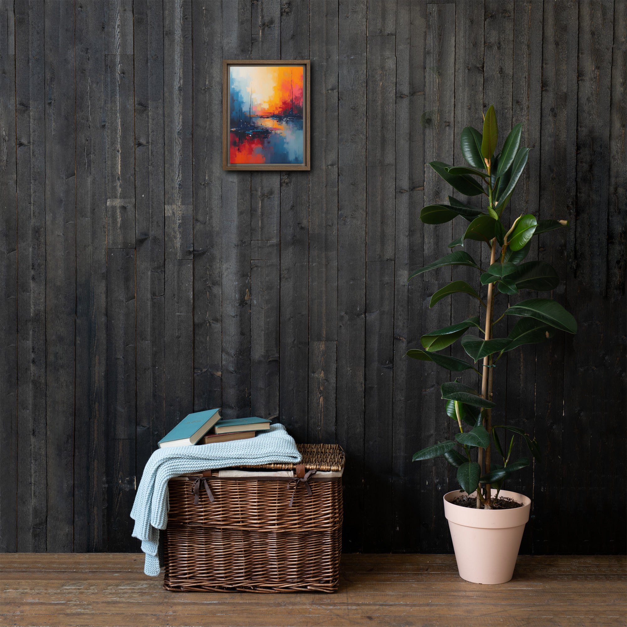 Wicker basket with towels and books against a dark wooden wall with a colorful abstract painting.