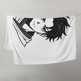 Towel with anime character design hanging on a line against a gray background