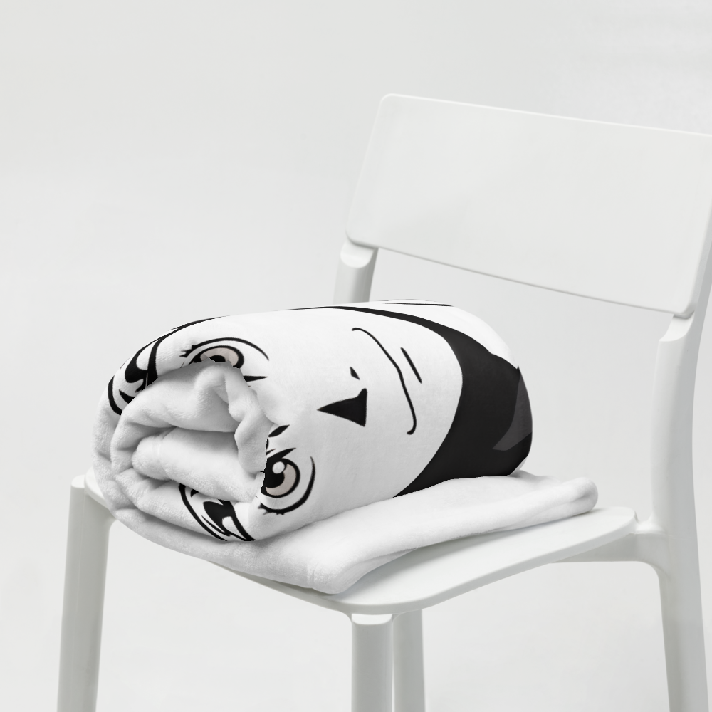 Black and white plush toy resembling a cartoon character on a white chair.