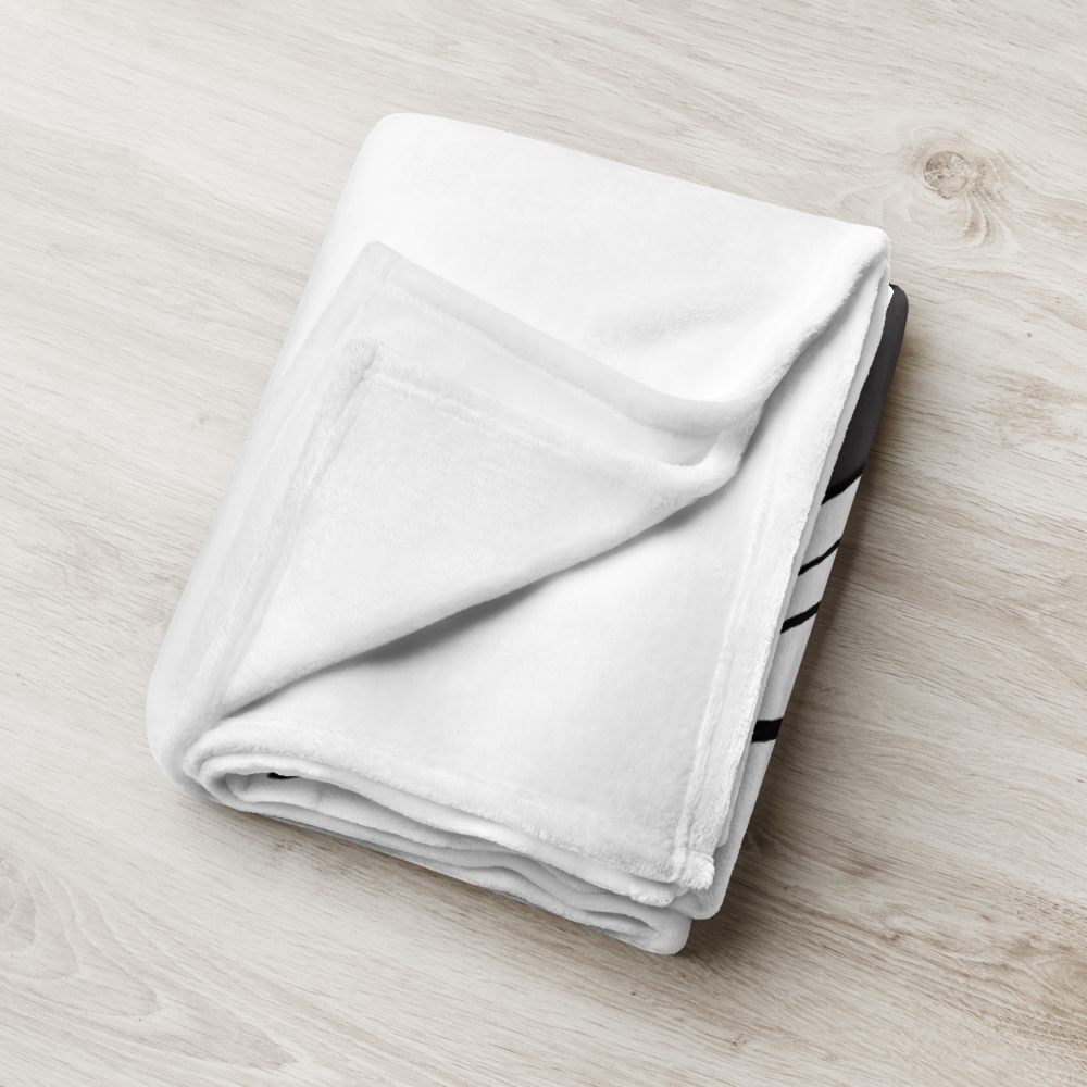 Folded white towel on a light wooden surface