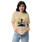Person wearing a beige t-shirt with a graphic design and text on a white background