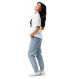 Person wearing a white t-shirt with a graphic design and light blue jeans on a white background