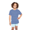 Child wearing a blue geometric patterned shirt and light blue shorts on a white background