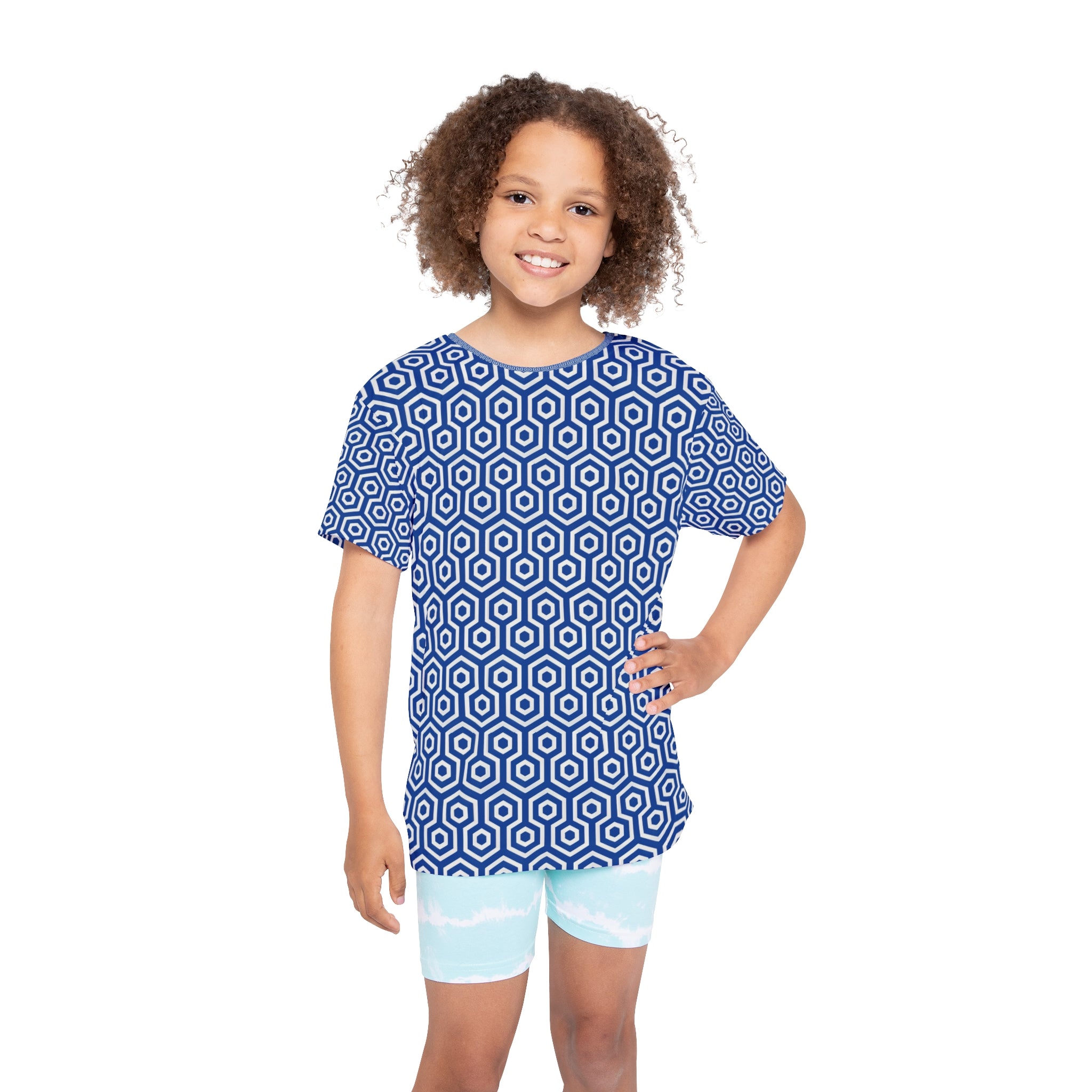 Child wearing a blue geometric patterned shirt and light blue shorts on a white background