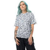 Person wearing a white t-shirt with blue floral pattern on a white background