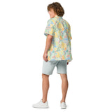 Person wearing a colorful floral shirt and light shorts on a white background