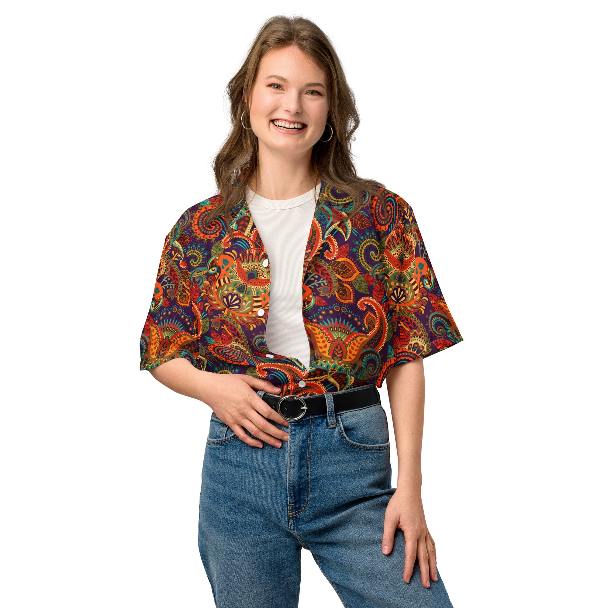 Woman wearing a colorful patterned shirt and blue jeans on a white background