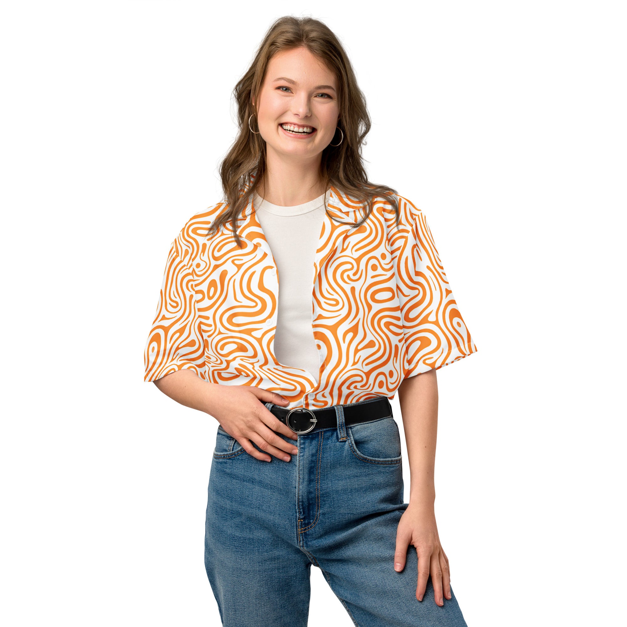 Woman wearing an orange and white patterned blouse with a white background