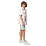 Man wearing a colorful patterned shirt and light shorts on a white background
