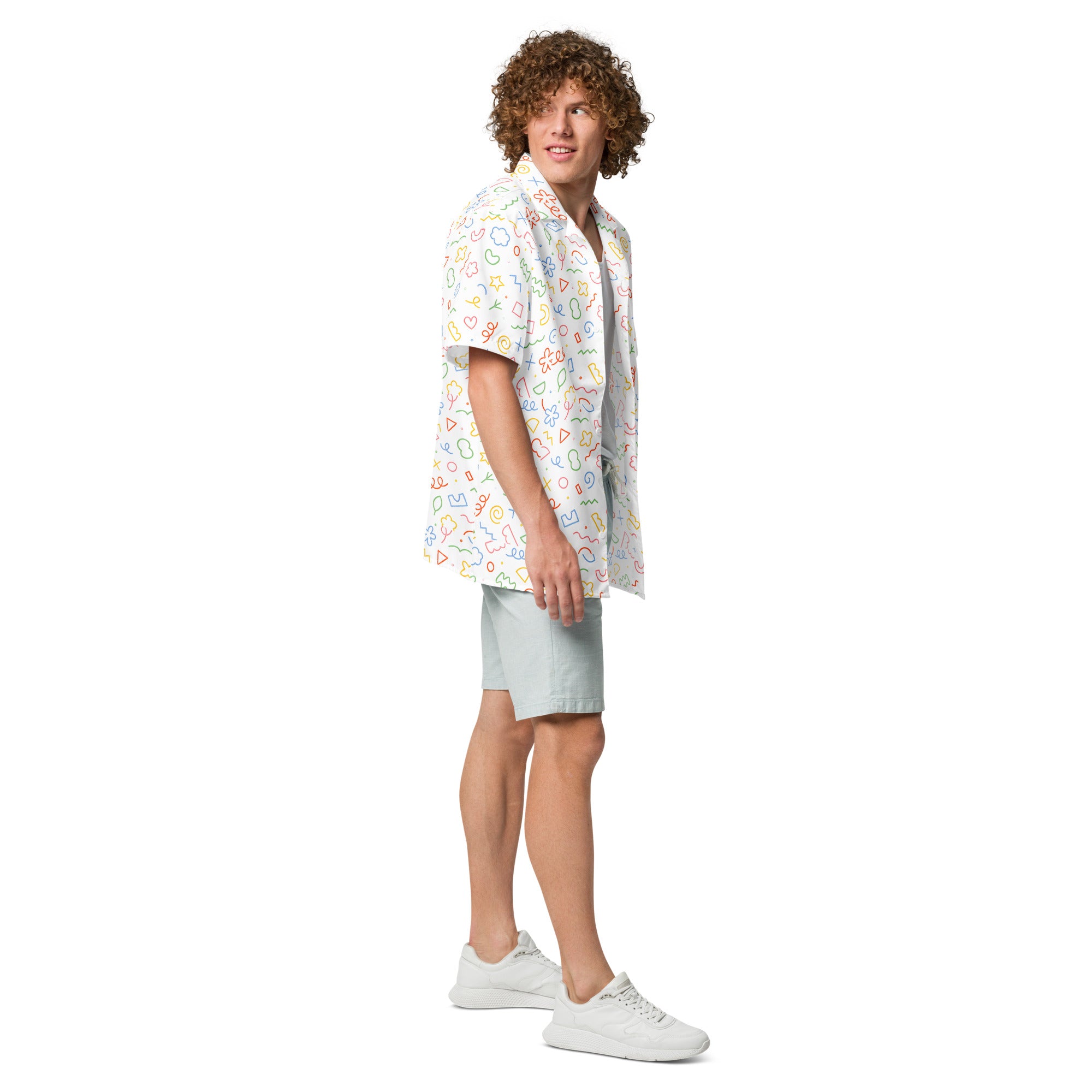 Man wearing a colorful patterned shirt and light shorts on a white background