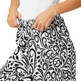Black and white patterned skirt worn by a person on a white background