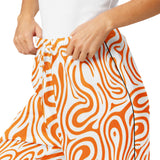 Orange and white patterned pants with a person wearing them on a white background