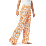 Orange and white patterned pants worn by a person on a white background