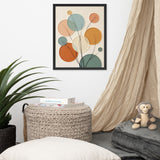 Decorative abstract art piece on a wall above a woven basket with books, a plush monkey toy, and pillows.