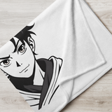 White towel with black and white anime character design on a wooden surface